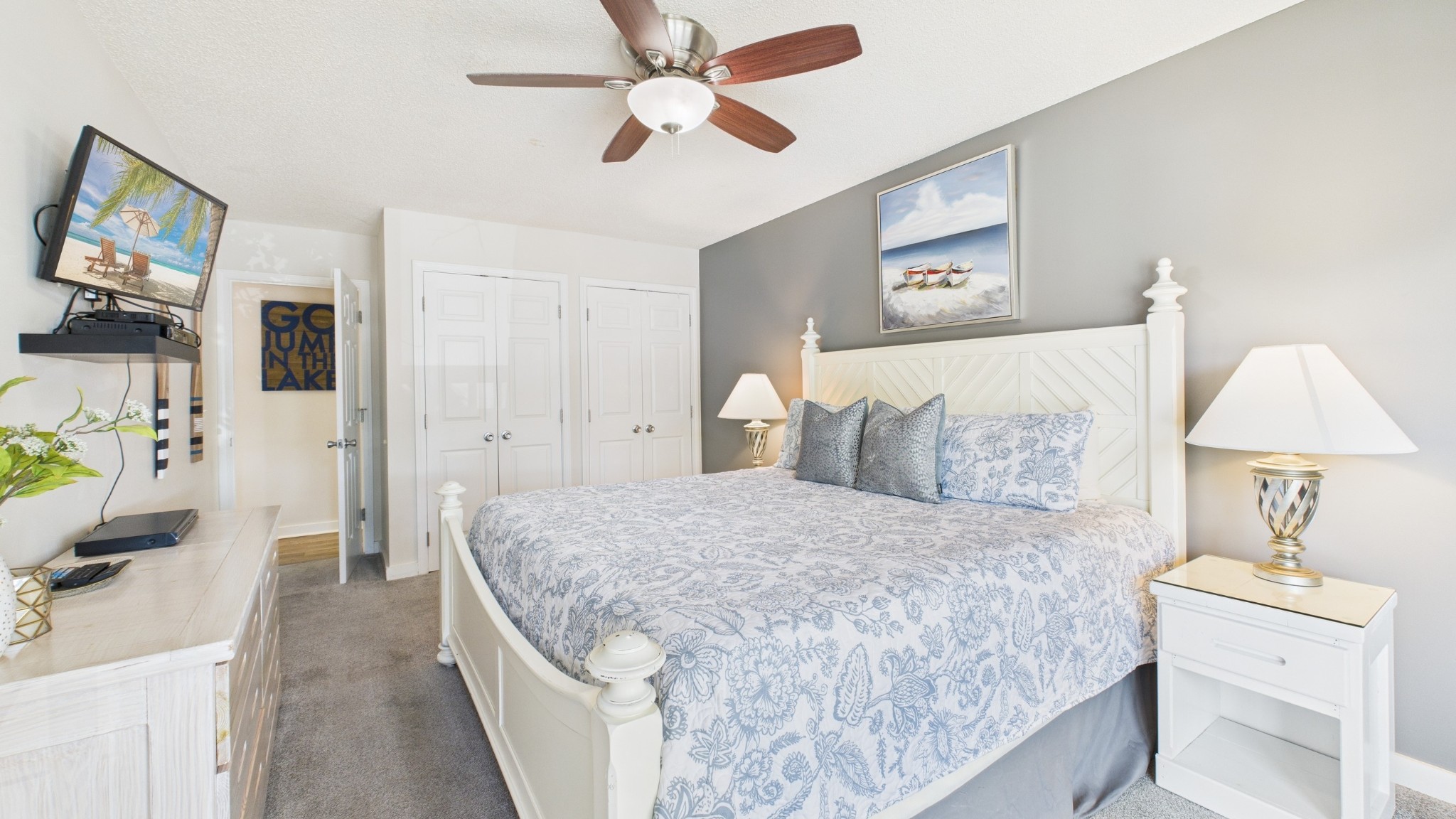 103 Harbor View Drive Grand Rivers, KY 42045 - Photo 23 of 38 a spacious bedroom with a bed and a chandelier