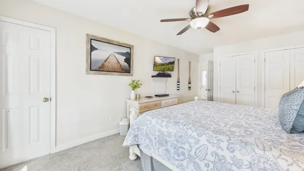 a bedroom with a large bed and a chandelier