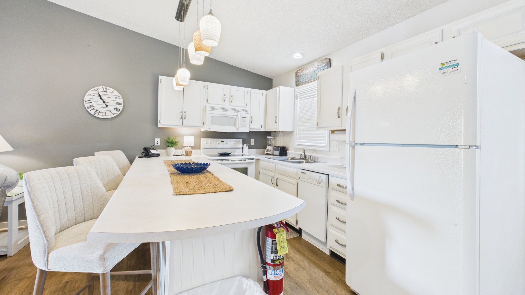 103 Harbor View Drive Grand Rivers, KY 42045 - Photo 32 of 38 a kitchen with stainless steel appliances a refrigerator a stove a sink a dining table and chairs