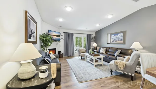 a living room with furniture a window and a fireplace