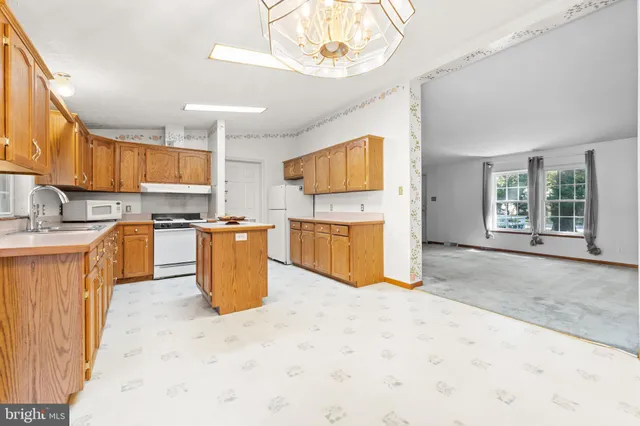 a kitchen with a refrigerator and a sink