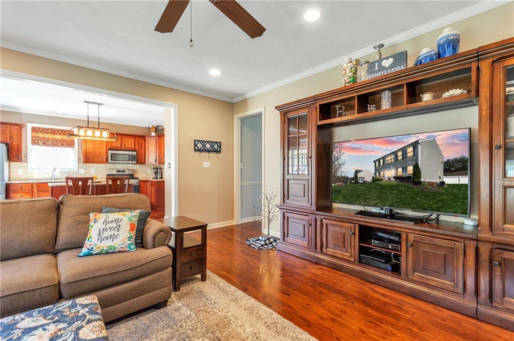 5012 Silver Oaks Drive McKees Rocks, PA 15136 - Photo 13 of 25 a living room with furniture a flat screen tv and a floor to ceiling window