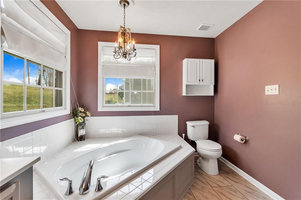 5012 Silver Oaks Drive McKees Rocks, PA 15136 - Photo 18 of 25 a spacious bathroom with a granite countertop toilet a sink and bathtub