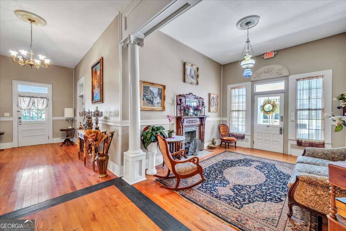 212 East Union Street Vienna, GA 31092 - Photo 13 of 62 a living room filled with furniture and a chandelier