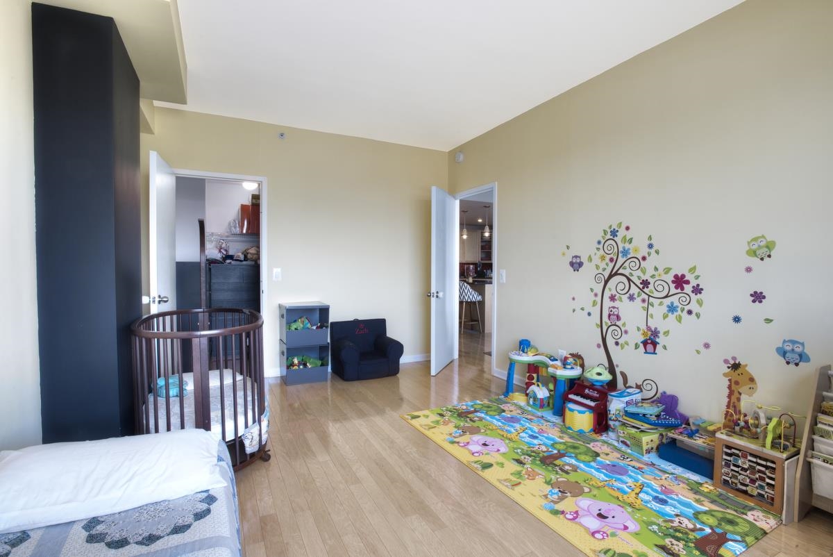 700 Grove Street, Unit 12J Jersey City, NJ 07310 - Photo 11 of 16 a bedroom with a bed and a workspace