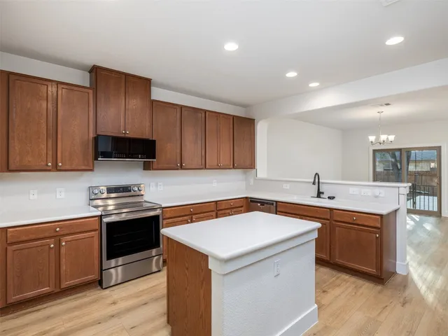 a kitchen that has a sink and a stove in it