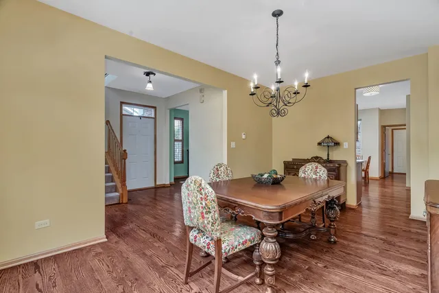 a dining room with furniture and wooden floor