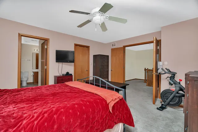 a bed room with a bed and a flat tv screen