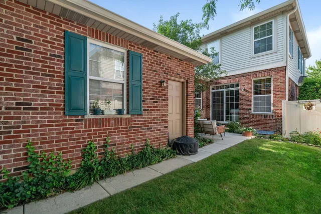 a front view of a house with a yard and outdoor seating