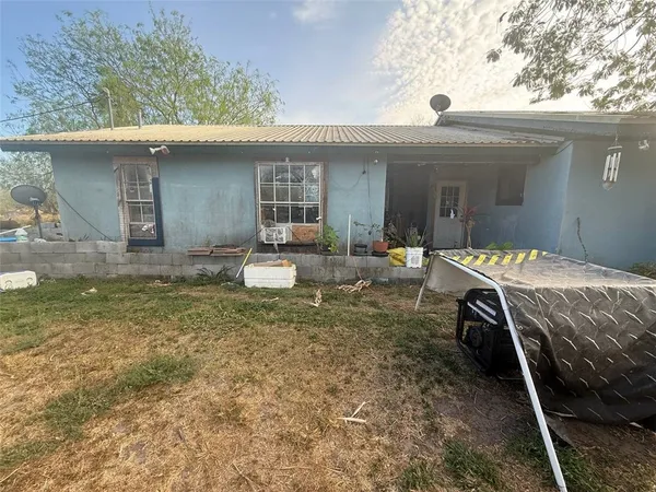 a view of a house with backyard porch and furniture