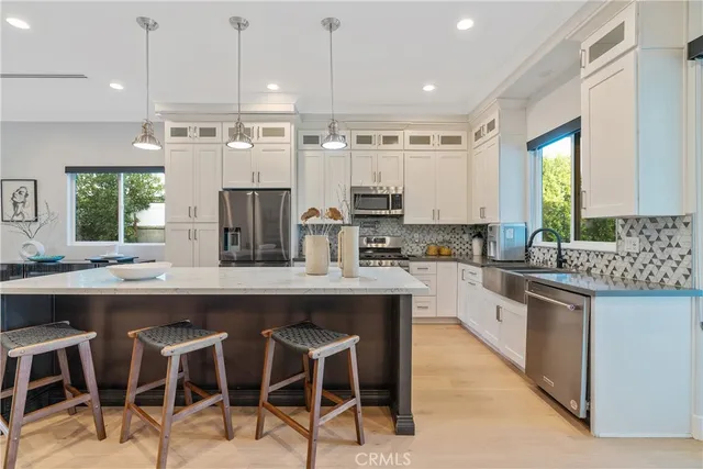 a kitchen with cabinets and chairs