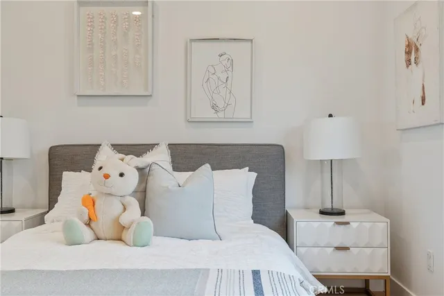 a bedroom with a bed and the lamp