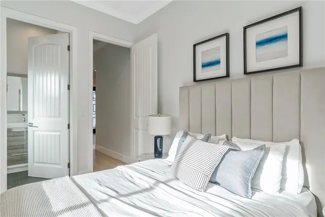 a bedroom with a bed and a painting on the wall