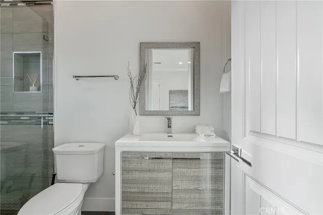 a bathroom with a sink toilet and mirror