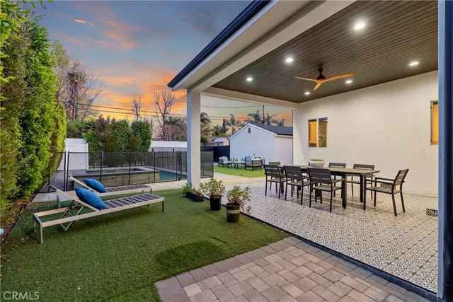 a view of a patio with a table and chairs