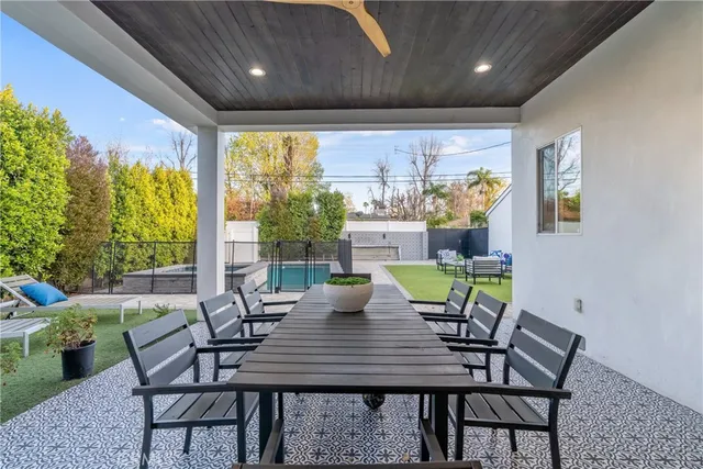 a view of a dining room with furniture a chandelier and wooden floor