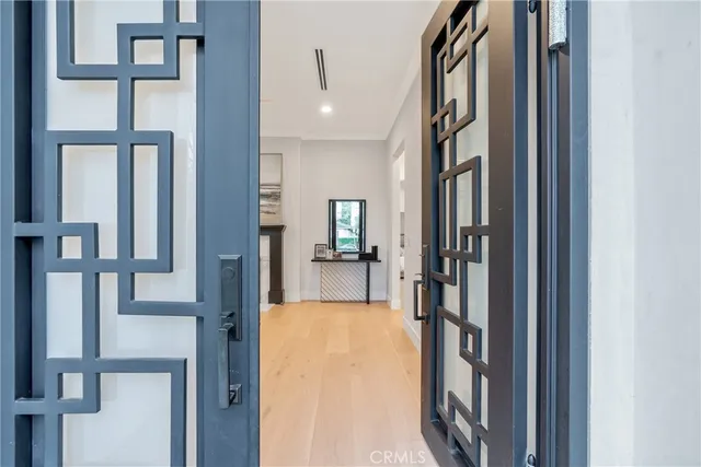 a view of a hallway with a livingroom and furniture