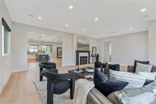 a living room with fireplace furniture and a wooden floor