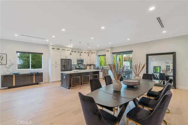 a large kitchen with a table and chairs