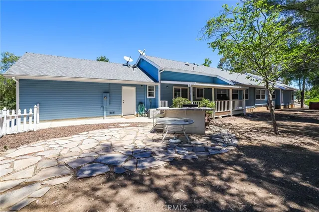 a backyard of a house with yard and outdoor seating