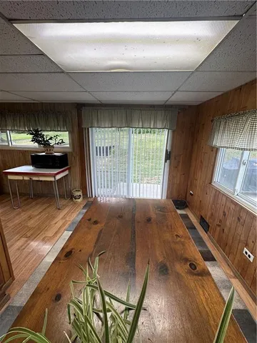 a view of a bedroom with wooden floor and furniture