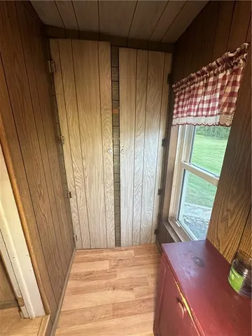 a view of water heater room with wooden floor