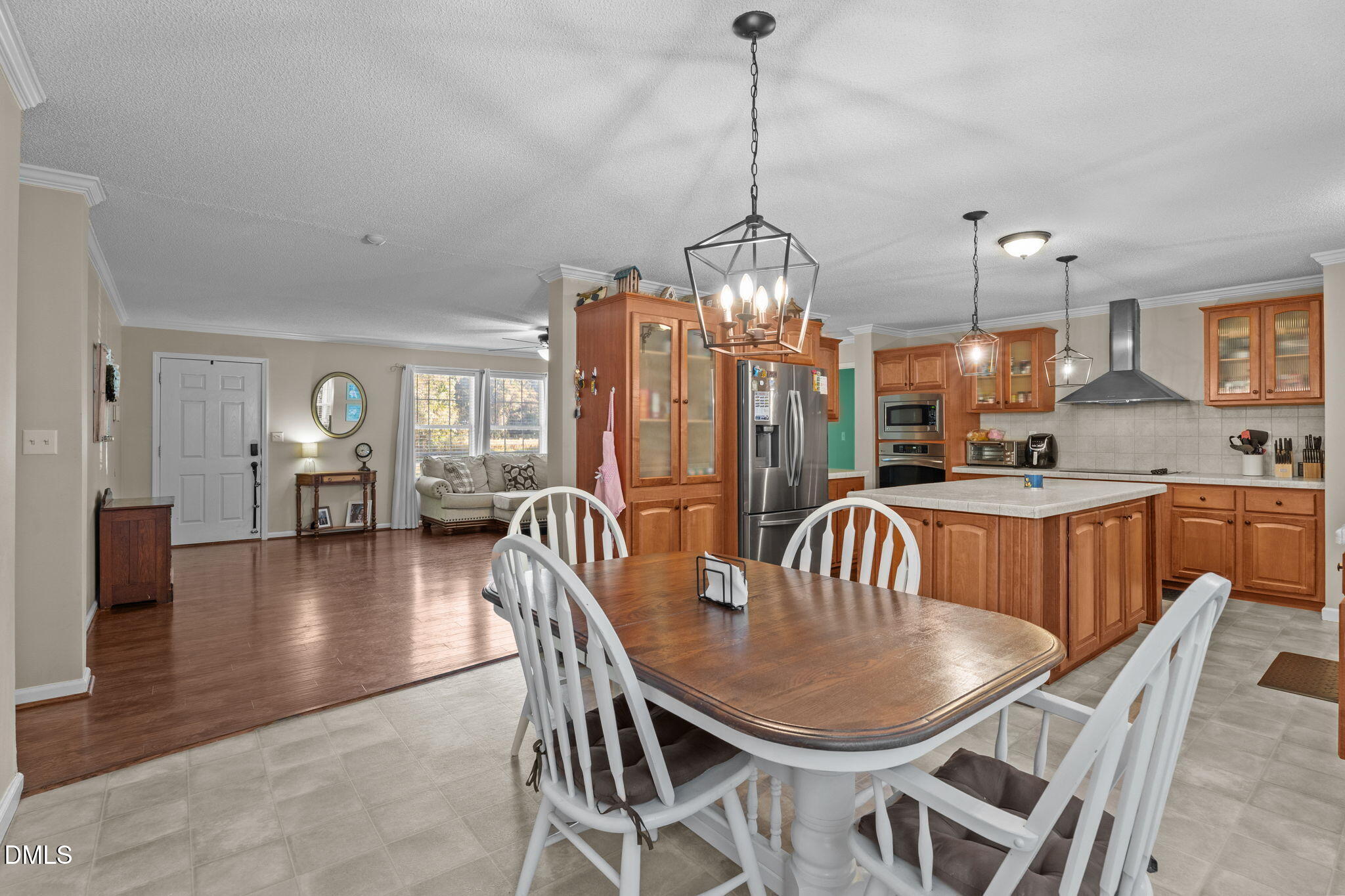 2450 Frazier Road Middlesex, NC 27557 - Photo 17 of 50 a dining room with furniture a chandelier and wooden floor