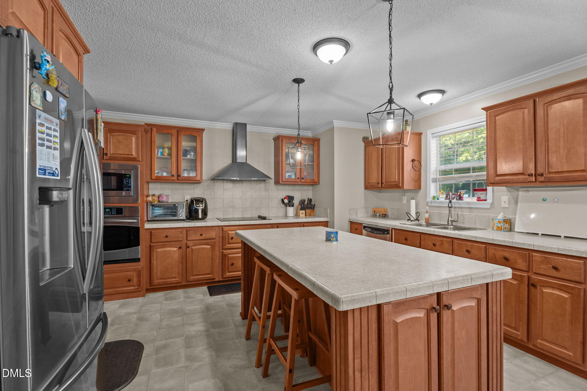 2450 Frazier Road Middlesex, NC 27557 - Photo 19 of 50 a kitchen with a stove a sink a center island and cabinets