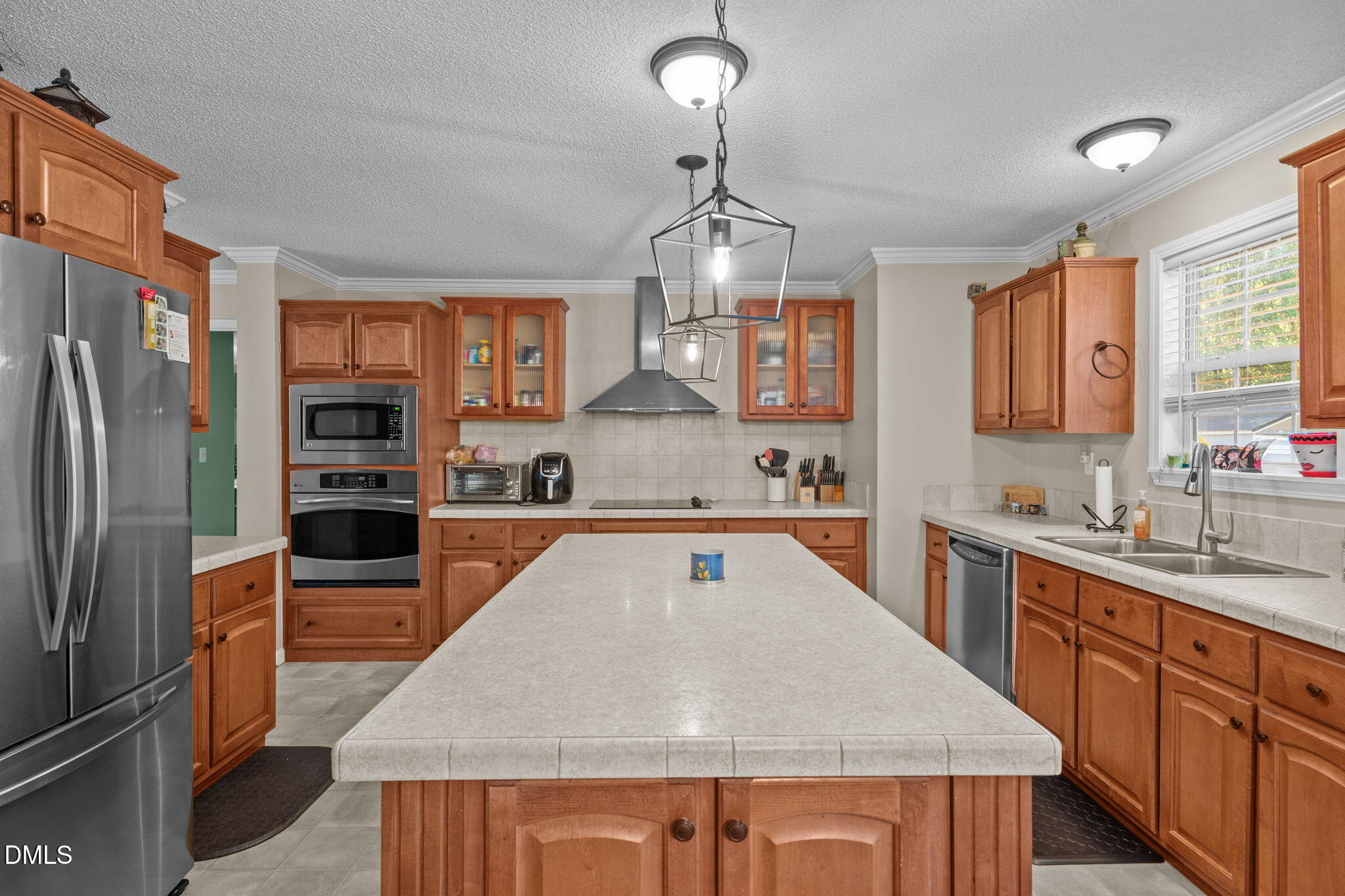 2450 Frazier Road Middlesex, NC 27557 - Photo 20 of 50 a large kitchen with stainless steel appliances granite countertop a refrigerator a sink dishwasher a oven and a dining table with wooden floor