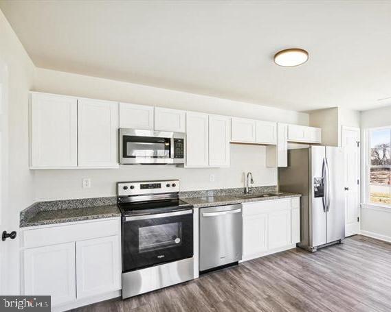 100 Metcalf Road Chestertown, MD 21620 - Photo 7 of 16 a kitchen with a sink a stove a refrigerator and white cabinets
