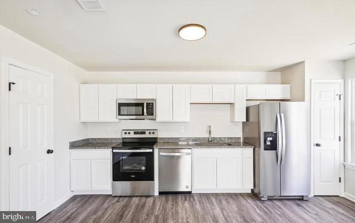 100 Metcalf Road Chestertown, MD 21620 - Photo 8 of 16 a kitchen with stainless steel appliances granite countertop a refrigerator and white cabinets