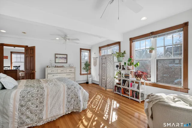 a bedroom with furniture and a large window