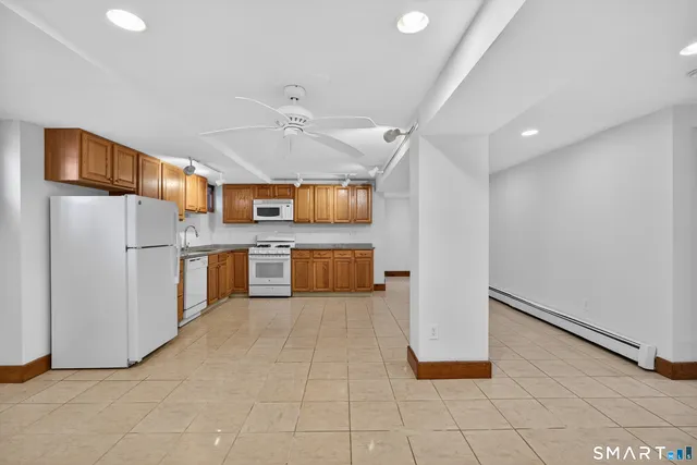 a kitchen with stainless steel appliances a refrigerator and a stove top oven