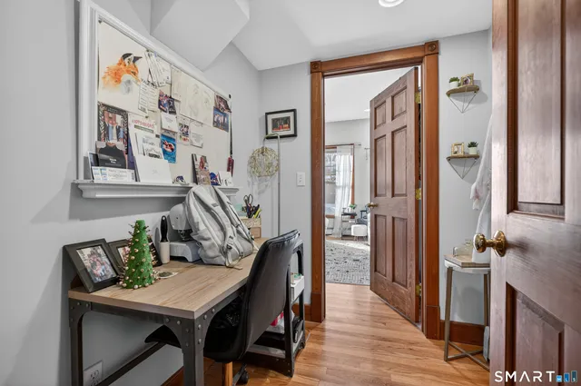 a view of a dining room with furniture a rug and wooden floor