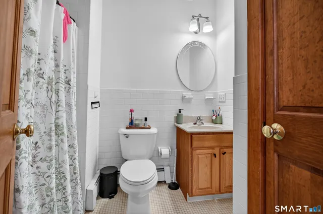 a bathroom with a toilet sink and mirror