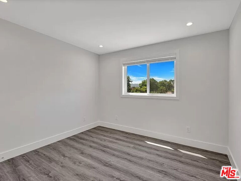 5750 Kester Avenue Van Nuys, CA 91411 - Photo 11 of 21 a view of empty room with wooden floor