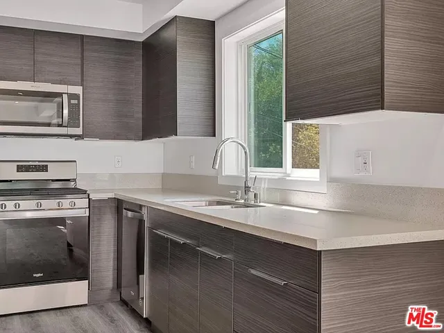a kitchen with a sink and a stove