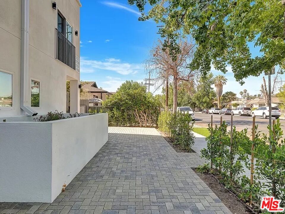 5750 Kester Avenue Van Nuys, CA 91411 - Photo 19 of 21 a view of a patio with table and chairs and potted plants