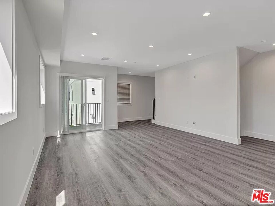 5750 Kester Avenue Van Nuys, CA 91411 - Photo 4 of 21 a view of an empty room with wooden floor