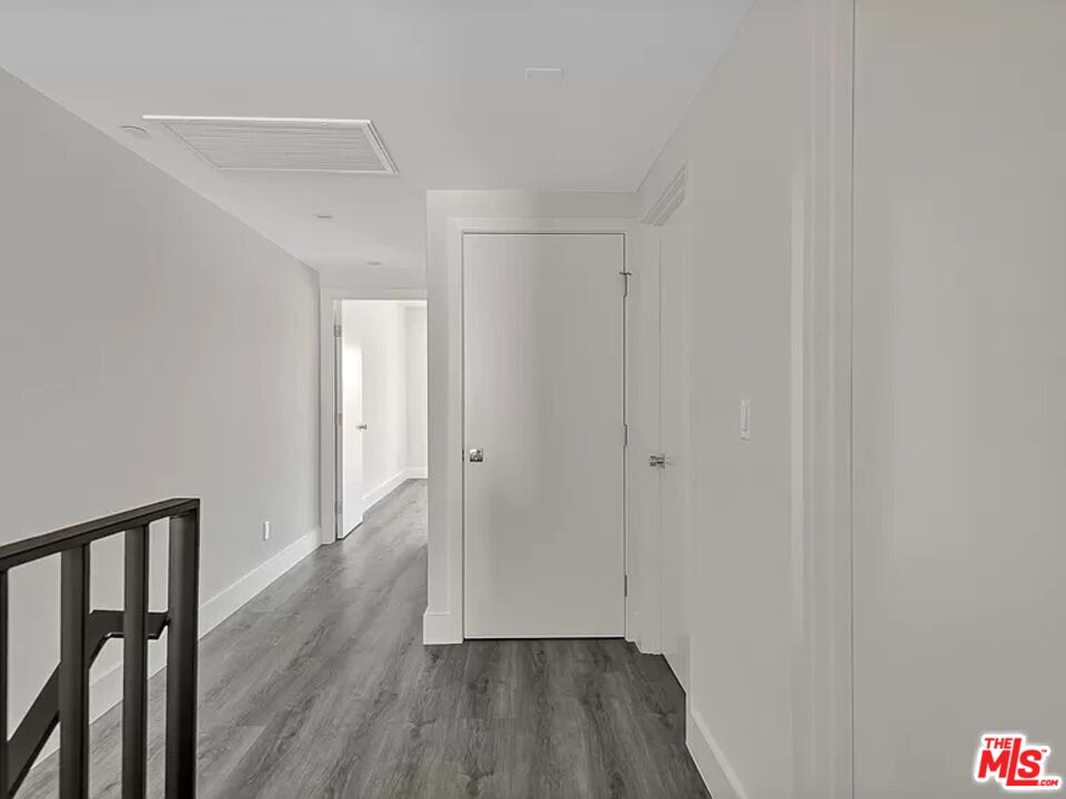 5750 Kester Avenue Van Nuys, CA 91411 - Photo 7 of 21 a view of a hallway with wooden floor