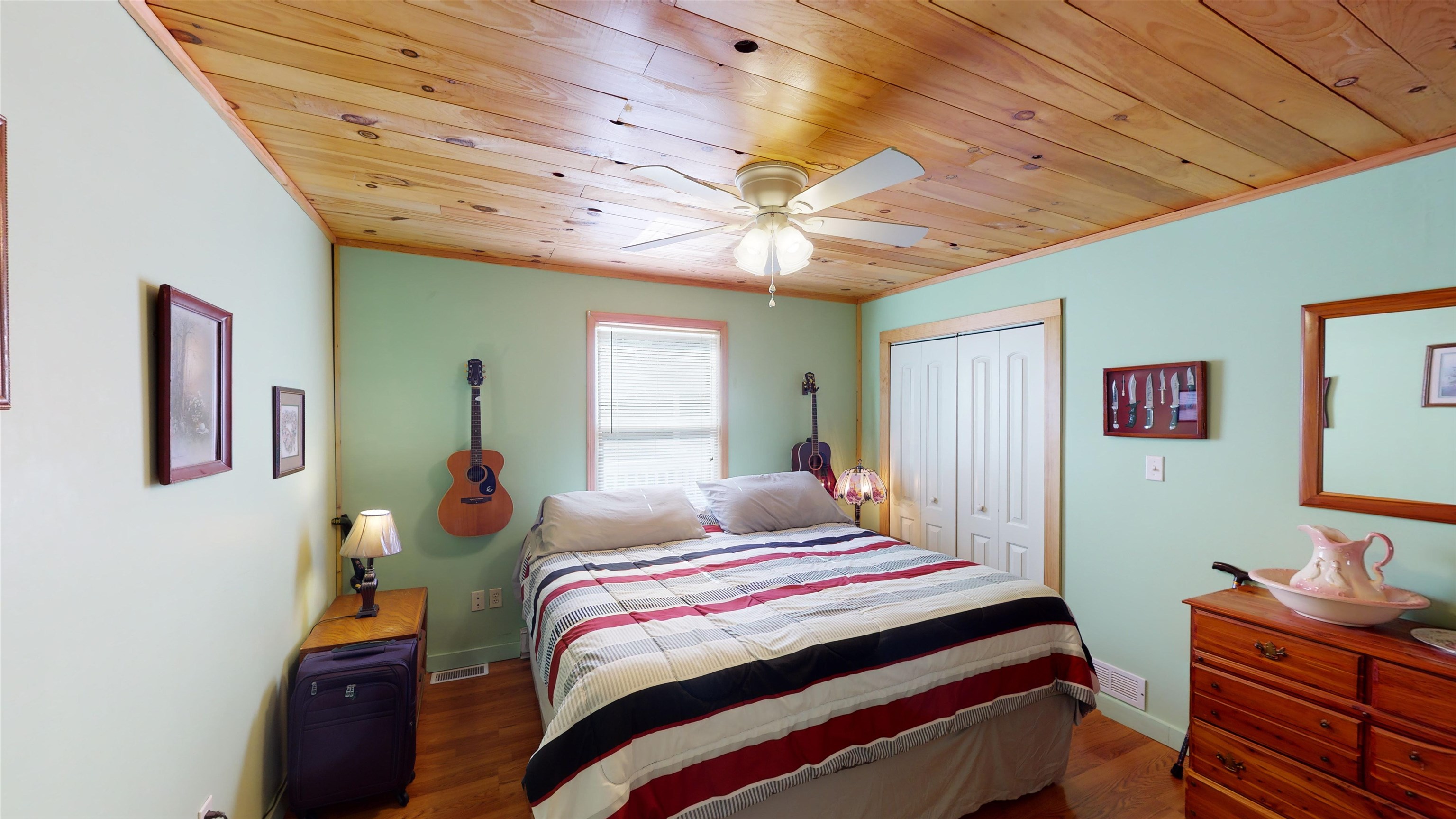 60 Bluebird Road Counce, TN 38326 - Photo 9 of 22 a bedroom with a bed and a chandelier