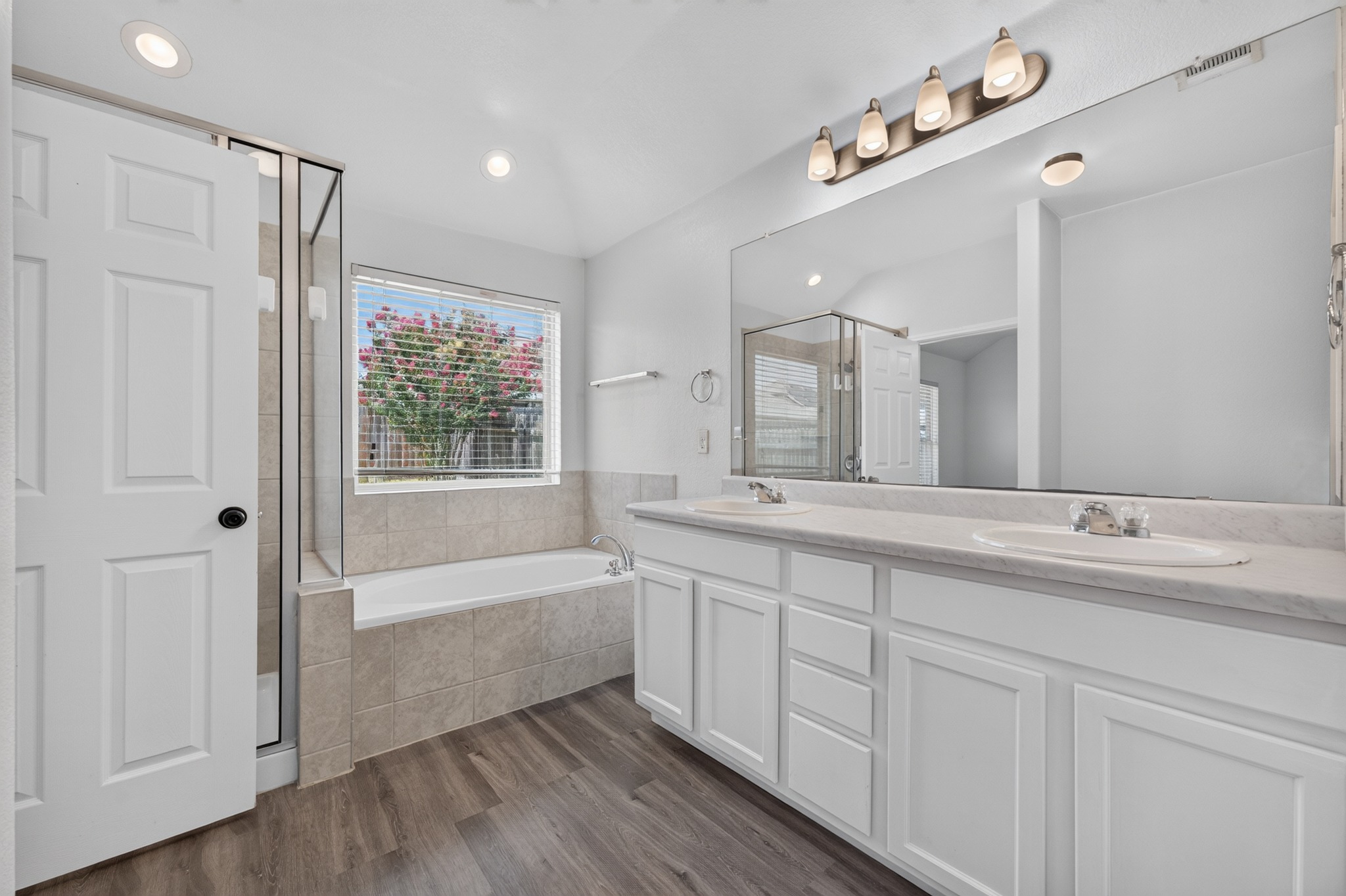 278 Noddy Road Buda, TX 78610 - Photo 13 of 17 Primary bath with double vanity, spacious soaking tub, and walk-in shower.
