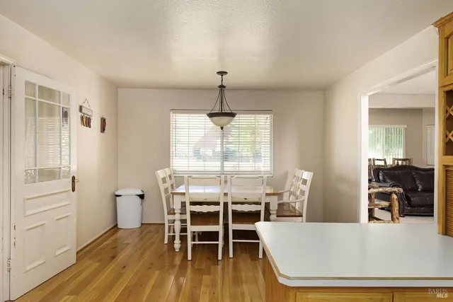a living room with furniture a wooden floor and a window