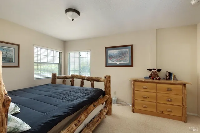 a bedroom with a bed and with furniture