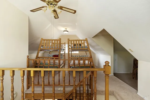 a view of staircase with railing and white walls