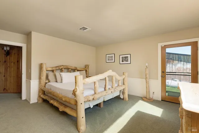 a bed room with a bed and a chair