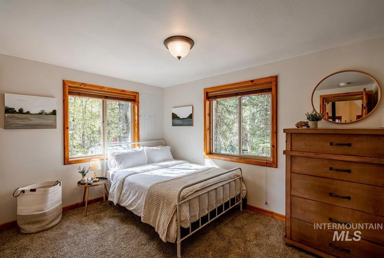 1409 Paul Bunyan Road McCall, ID 83638 - Photo 10 of 16 Bedroom featuring dark carpet