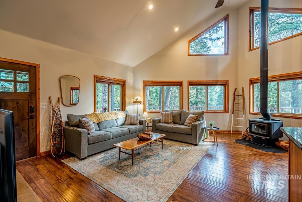 1409 Paul Bunyan Road McCall, ID 83638 - Photo 5 of 16 Living area featuring hardwood / wood-style flooring, a wood stove, recessed lighting, a ceiling fan, and lofted ceiling