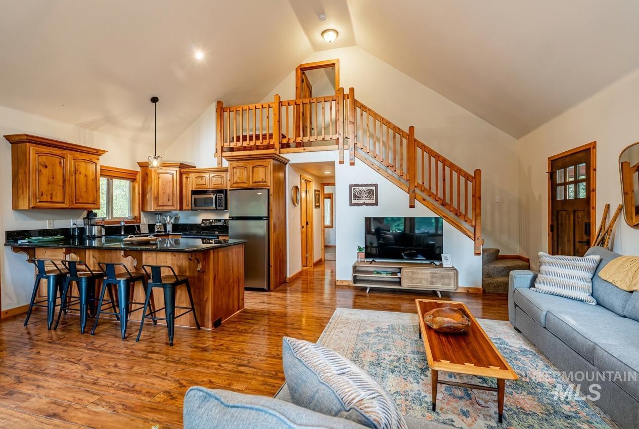 1409 Paul Bunyan Road McCall, ID 83638 - Photo 7 of 16 Living room with light wood-style floors and a high ceiling
