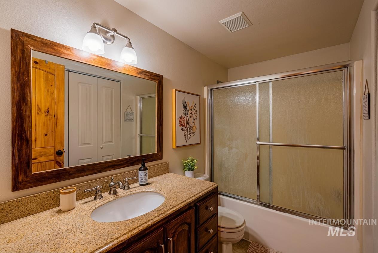 1409 Paul Bunyan Road McCall, ID 83638 - Photo 9 of 16 Bathroom featuring vanity and combined bath / shower with glass door